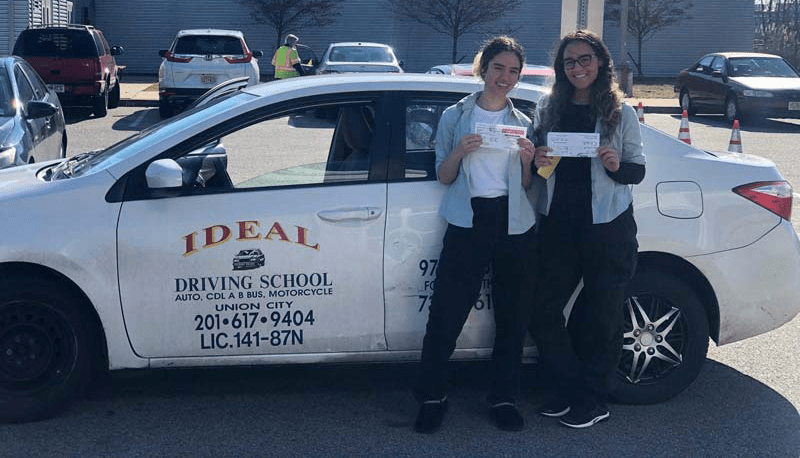 Two Girls Standing Near a Car